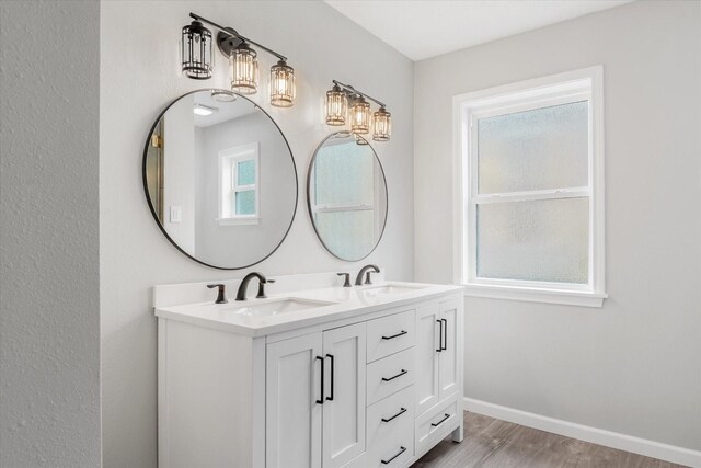 3518 Ball, Galveston, TX 77550 - full bathroom with wood finished floors, double vanity, and baseboards