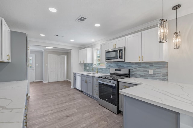 3518 Ball, Galveston, TX 77550 - kitchen with appliances with stainless steel finishes, a sink, light stone counters, decorative backsplash, and crown molding