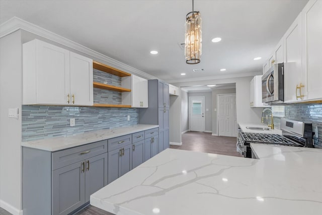 3518 Ball, Galveston, TX 77550 - kitchen featuring appliances with stainless steel finishes, baseboards, a sink, open shelves, and light stone counters
