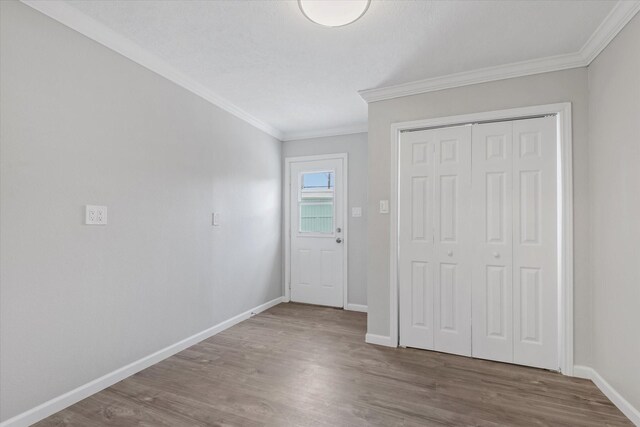 3518 Ball, Galveston, TX 77550 - entryway featuring crown molding, baseboards, and wood finished floors