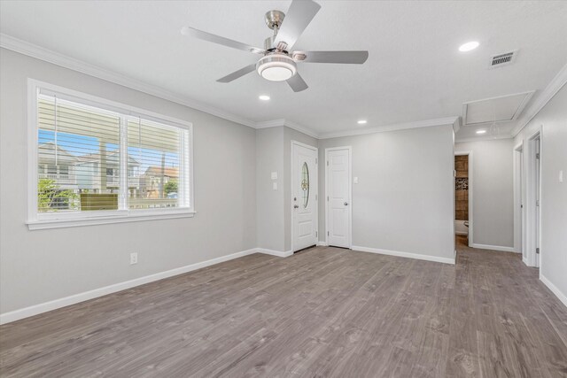 3518 Ball, Galveston, TX 77550 - spare room with attic access, crown molding, baseboards, ceiling fan, and wood finished floors