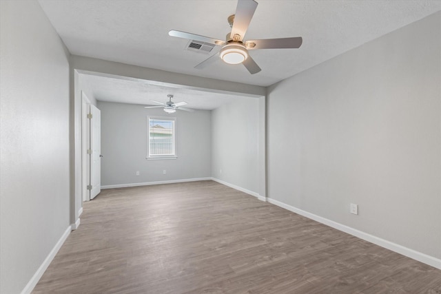 3518 Ball, Galveston, TX 77550 - spare room with a ceiling fan, wood finished floors, and baseboards