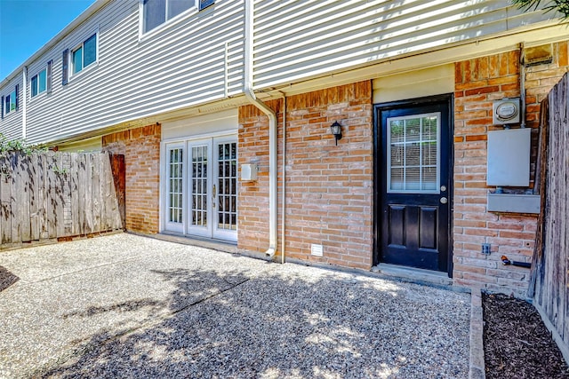 13060 Trail Hollow Dr Unit 3060, Houston, TX 77079 - view of exterior entry with brick siding, fence, and a patio area