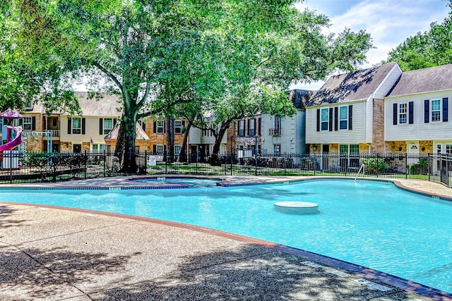 13060 Trail Hollow Dr Unit 3060, Houston, TX 77079 - community pool featuring fence, a hot tub, and a residential view