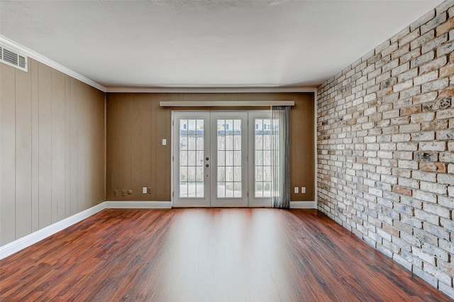 13060 Trail Hollow Dr Unit 3060, Houston, TX 77079 - spare room featuring dark wood-style floors, french doors, baseboards, ornamental molding, and brick wall