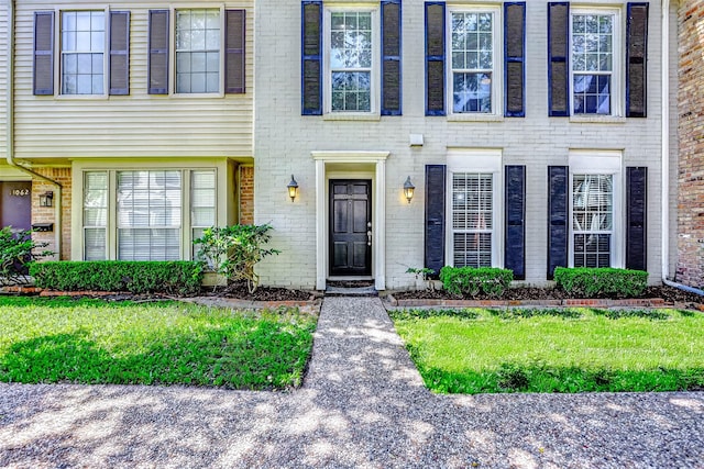13060 Trail Hollow Dr Unit 3060, Houston, TX 77079 - doorway to property featuring brick siding and a lawn
