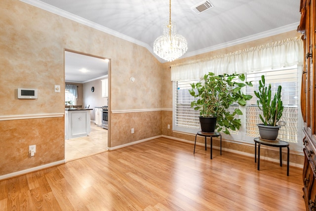 sitting room with a chandelier, crown molding, light wood finished floors, and baseboards