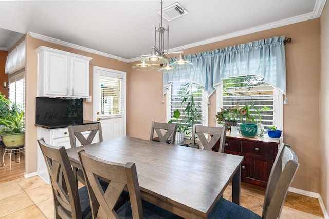 dining space with ornamental molding, baseboards, and light tile patterned flooring