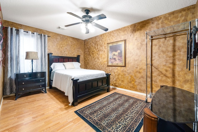 bedroom featuring wood finished floors, ceiling fan, and baseboards