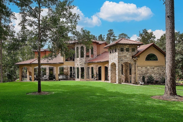 280 Sundog Rd, Huntsville, TX 77340 - back of property with stone siding, a lawn, a tiled roof, and stucco siding