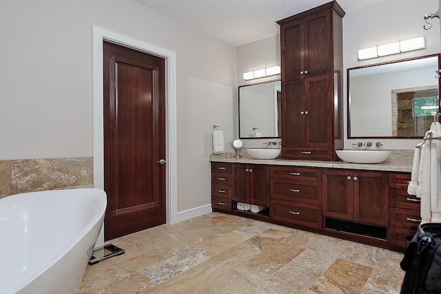 280 Sundog Rd, Huntsville, TX 77340 - bathroom with a soaking tub, stone tile floors, and double vanity