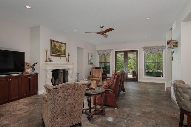 280 Sundog Rd, Huntsville, TX 77340 - living area with dark stone finish floors, ceiling fan, a fireplace, recessed lighting, and baseboards