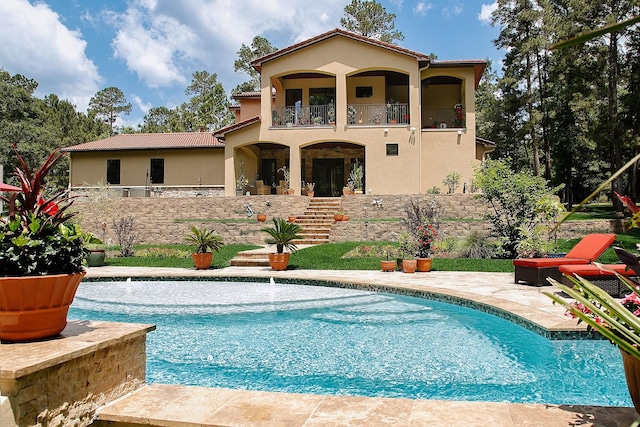 280 Sundog Rd, Huntsville, TX 77340 - rear view of property featuring a balcony, stucco siding, and an outdoor pool