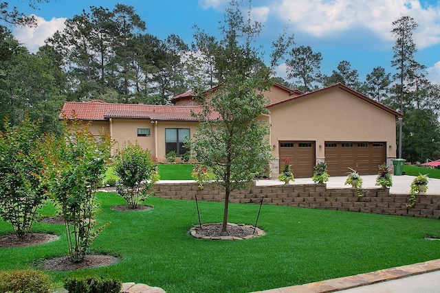 280 Sundog Rd, Huntsville, TX 77340 - mediterranean / spanish-style house with a front lawn, stucco siding, a garage, concrete driveway, and a tiled roof