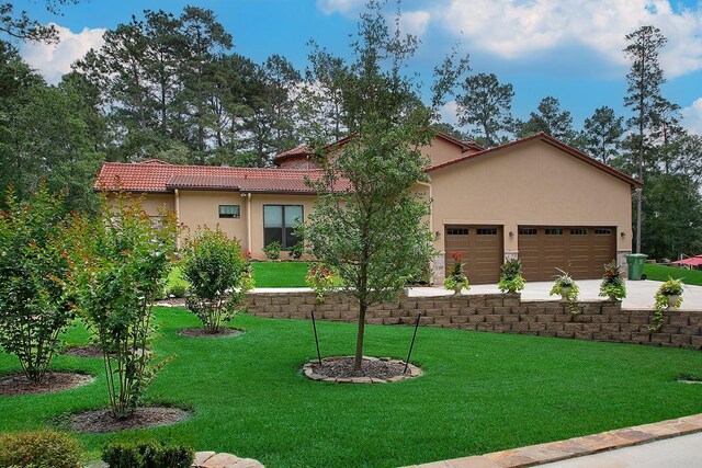 280 Sundog Rd, Huntsville, TX 77340 - mediterranean / spanish-style home featuring a front lawn, stucco siding, an attached garage, driveway, and a tiled roof