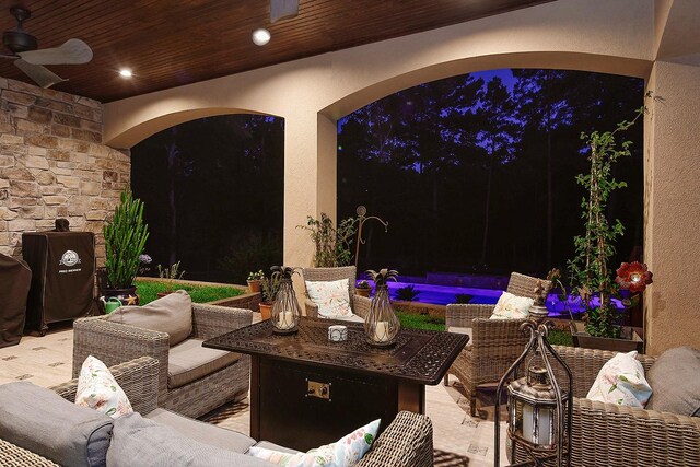 280 Sundog Rd, Huntsville, TX 77340 - patio at night with an outdoor living space, a patio area, a ceiling fan, and an outdoor pool