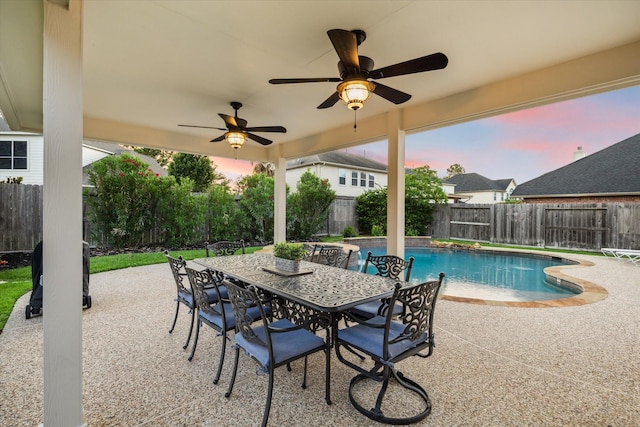 17815 Fairgrove Park Dr, Houston, TX 77095 - pool at dusk with a fenced backyard, a patio area, outdoor dining area, and a ceiling fan
