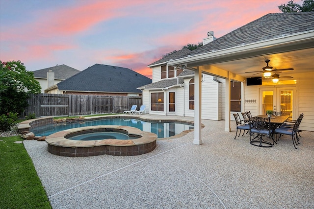 17815 Fairgrove Park Dr, Houston, TX 77095 - pool at dusk featuring an in-ground hot tub, ceiling fan, fence, and a patio