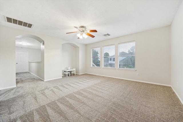 17815 Fairgrove Park Dr, Houston, TX 77095 - spare room featuring arched walkways, carpet floors, a ceiling fan, and baseboards