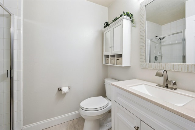 17815 Fairgrove Park Dr, Houston, TX 77095 - full bathroom featuring a shower stall, toilet, wood finished floors, baseboards, and vanity
