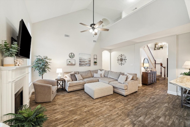17815 Fairgrove Park Dr, Houston, TX 77095 - living room with arched walkways, dark wood finished floors, high vaulted ceiling, a premium fireplace, and ceiling fan