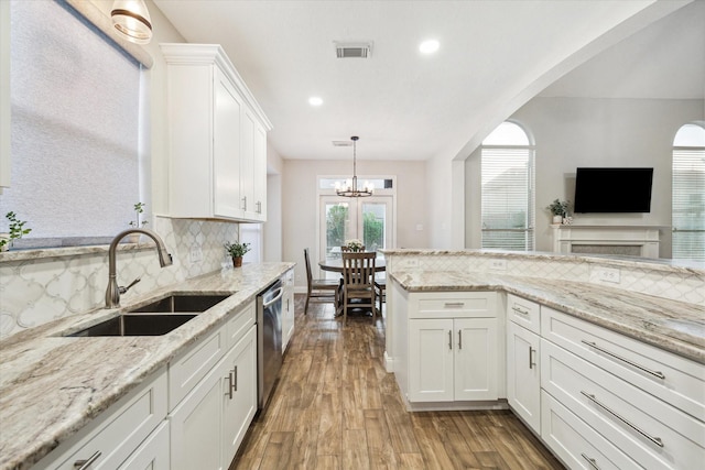 17815 Fairgrove Park Dr, Houston, TX 77095 - kitchen with a sink, stainless steel dishwasher, wood finished floors, tasteful backsplash, and recessed lighting