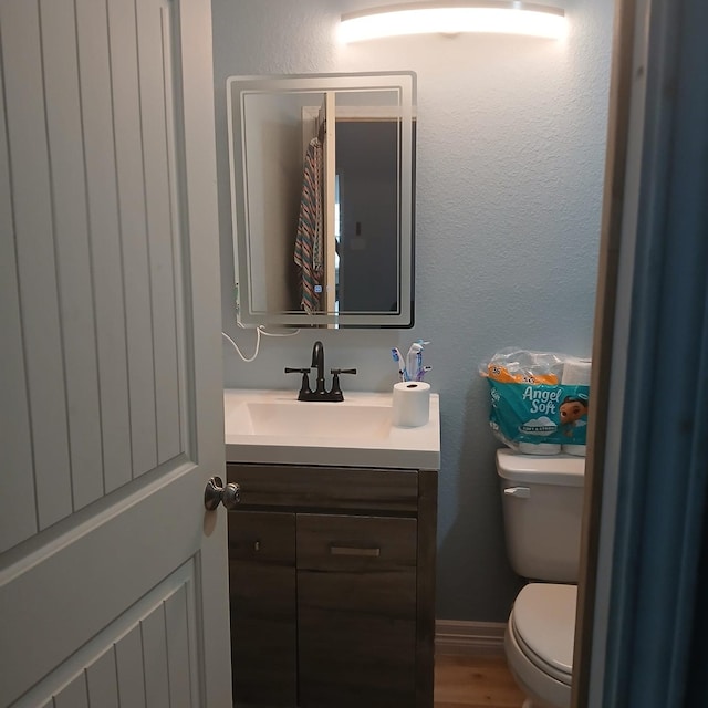 16514 Green Manor Dr, Humble, TX 77396 - half bath with toilet, vanity, and wood finished floors