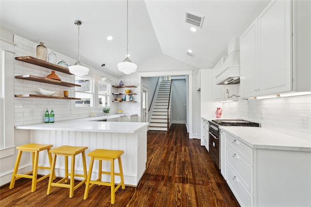 309 E 16th St, Houston, TX 77008 - kitchen featuring open shelves, stainless steel range, a peninsula, lofted ceiling, and backsplash