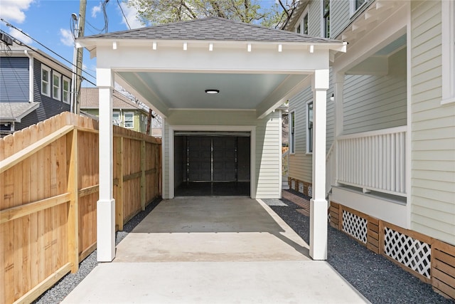 309 E 16th St, Houston, TX 77008 - doorway to property featuring roof with shingles, fence, and concrete driveway