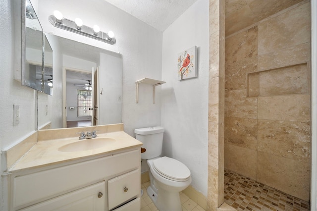 9537 Pagewood Ln Unit 9537, Houston, TX 77063 - bathroom featuring toilet, a tile shower, vanity, a ceiling fan, and tile patterned flooring