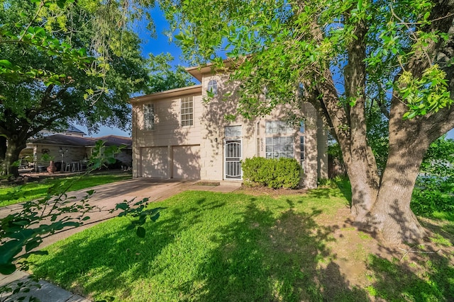 1502 Stevenage Ln, Channelview, TX 77530 - view of front of house with a garage, concrete driveway, a front lawn, and brick siding