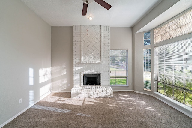 1502 Stevenage Ln, Channelview, TX 77530 - unfurnished living room featuring healthy amount of natural light, ceiling fan, carpet floors, a fireplace, and a textured ceiling