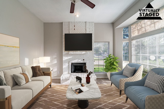 1502 Stevenage Ln, Channelview, TX 77530 - living room with a ceiling fan, a textured ceiling, and a fireplace