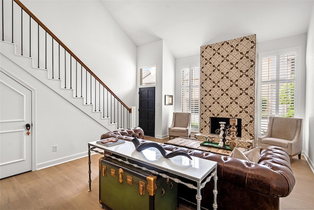 2421 Potomac Dr Unit C, Houston, TX 77057 - living area featuring wood finished floors, baseboards, stairs, and vaulted ceiling