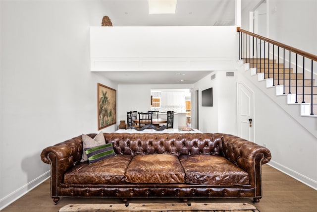 2421 Potomac Dr Unit C, Houston, TX 77057 - living room featuring wood finished floors, baseboards, stairs, and a towering ceiling