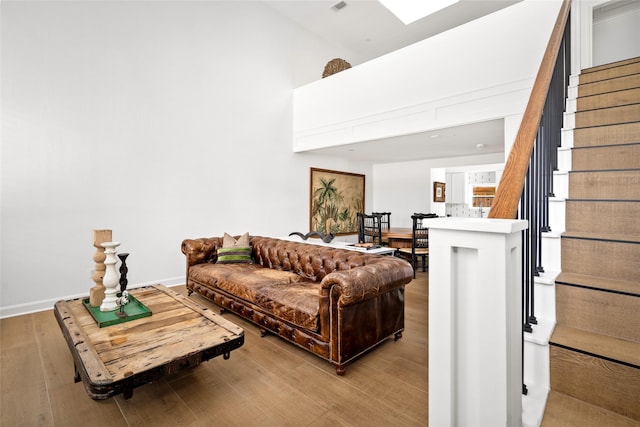 2421 Potomac Dr Unit C, Houston, TX 77057 - living area with stairway, wood finished floors, a towering ceiling, and baseboards