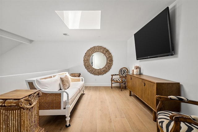 2421 Potomac Dr Unit C, Houston, TX 77057 - sitting room featuring a skylight, light wood-type flooring, and baseboards