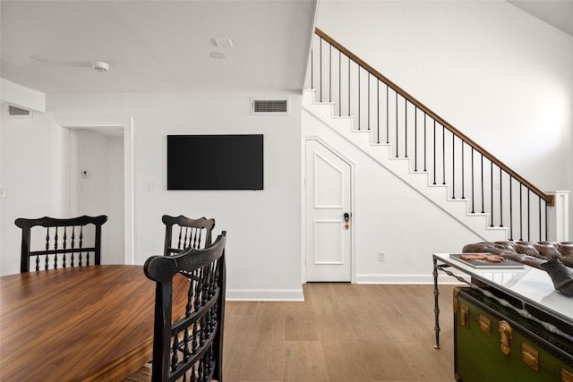 2421 Potomac Dr Unit C, Houston, TX 77057 - dining area with wood finished floors, baseboards, and stairs
