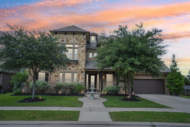 3115 Hillside Landing Trl, Katy, TX 77494 - view of front of house featuring driveway, a front yard, stone siding, an attached garage, and brick siding