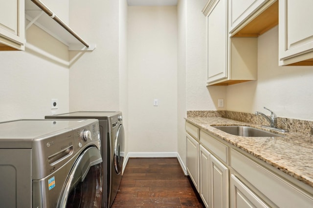 3115 Hillside Landing Trl, Katy, TX 77494 - washroom featuring washing machine and dryer, dark wood finished floors, cabinet space, and baseboards