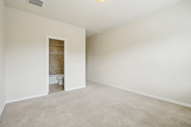 3115 Hillside Landing Trl, Katy, TX 77494 - unfurnished bedroom featuring light colored carpet, baseboards, and connected bathroom