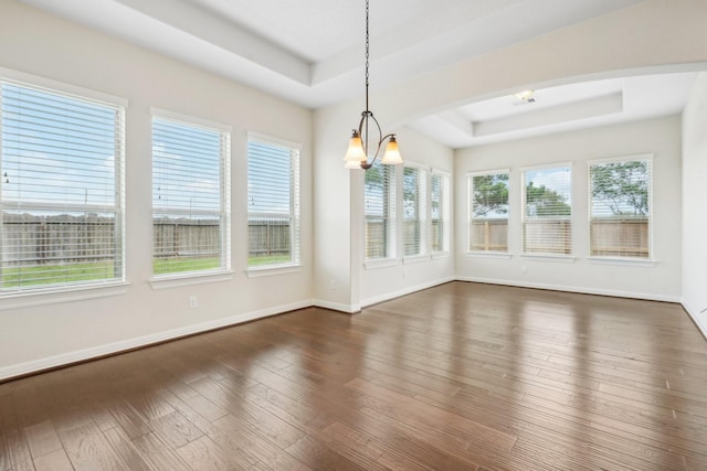 3115 Hillside Landing Trl, Katy, TX 77494 - unfurnished dining area featuring a tray ceiling, dark wood finished floors, and baseboards