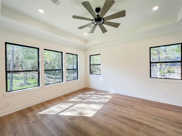 21332 Monarch Dr, Montgomery, TX 77316 - empty room with a tray ceiling, light wood-type flooring, a ceiling fan, baseboards, and recessed lighting