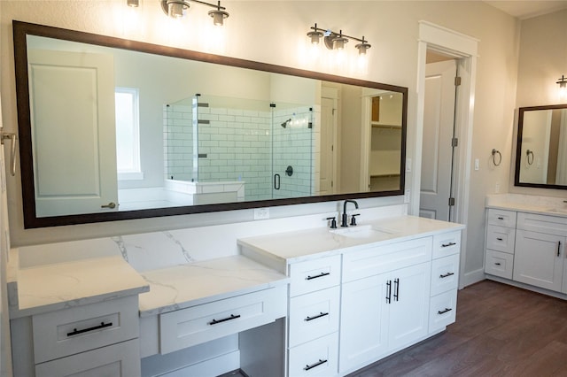 21332 Monarch Dr, Montgomery, TX 77316 - bathroom with a shower stall, wood finished floors, and two vanities