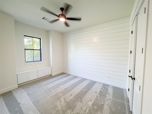 21332 Monarch Dr, Montgomery, TX 77316 - unfurnished room featuring light colored carpet, a ceiling fan, wood walls, and baseboards