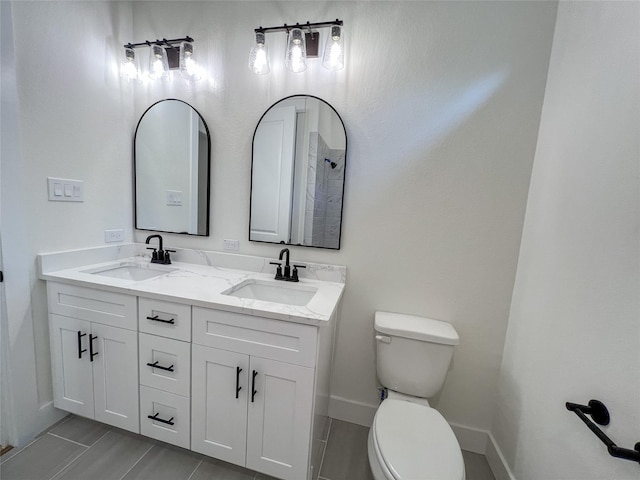 21332 Monarch Dr, Montgomery, TX 77316 - full bath featuring toilet, baseboards, double vanity, and tile patterned flooring