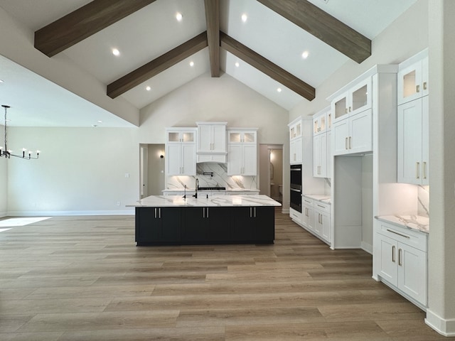 21332 Monarch Dr, Montgomery, TX 77316 - kitchen featuring a large island, light wood finished floors, white cabinets, high vaulted ceiling, and a chandelier