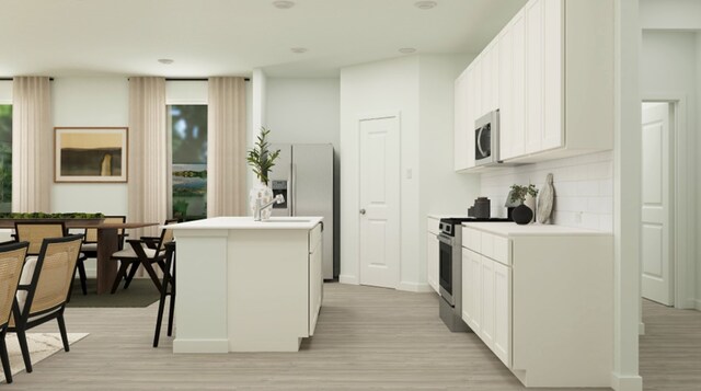 3035 Ruby Ridge Dr, Katy, TX 77493 - kitchen with appliances with stainless steel finishes, backsplash, light wood-style floors, a kitchen island with sink, and light countertops