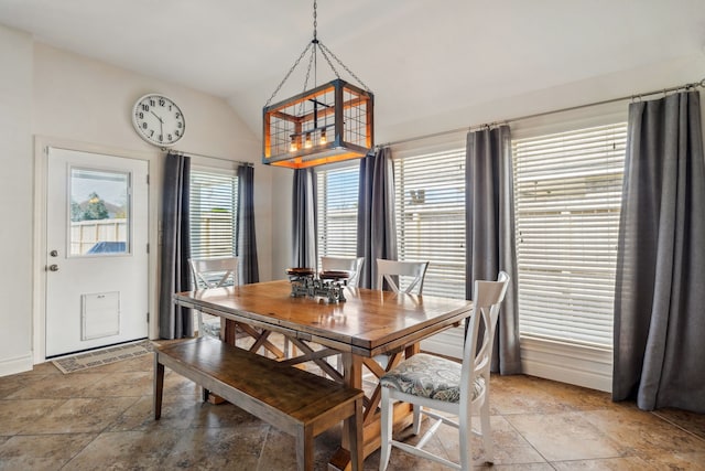 2850 Woodland Glen Ln, Conroe, TX 77385 - dining space with vaulted ceiling, light stone finish flooring, and baseboards