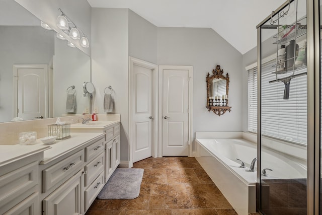 2850 Woodland Glen Ln, Conroe, TX 77385 - full bath featuring stone finish flooring, vaulted ceiling, vanity, a garden tub, and baseboards
